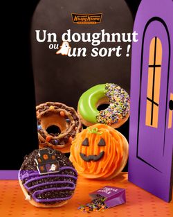 Colorful doughnuts featuring Halloween themes, surrounded by festive decorations.