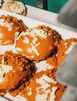 Close view of doughnuts with caramel glaze and white chocolate shavings at Krispy Kreme - CC O'Parinor.