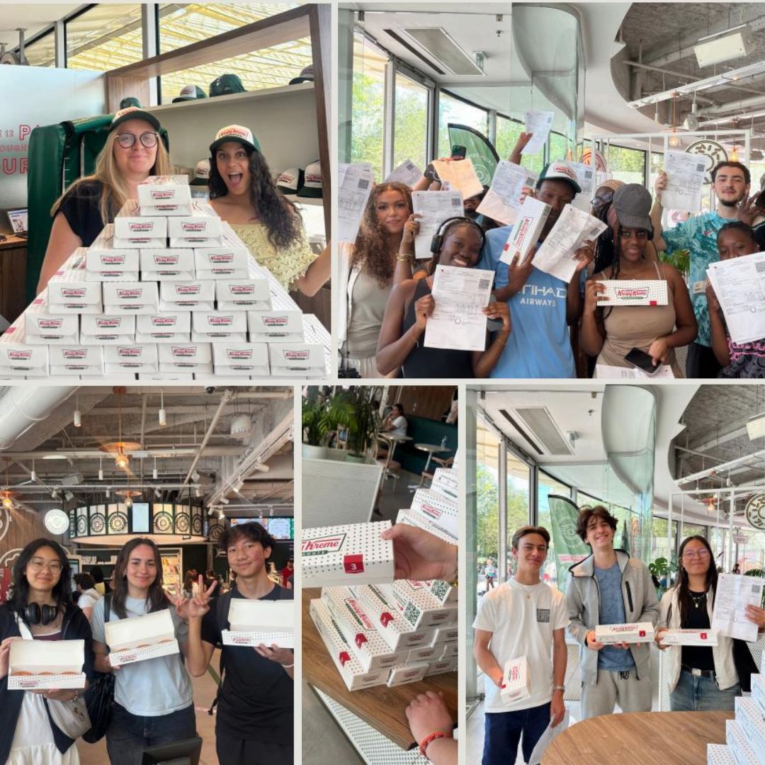 Visitors enjoying doughnuts at Krispy Kreme, showcasing dessert and café atmosphere.