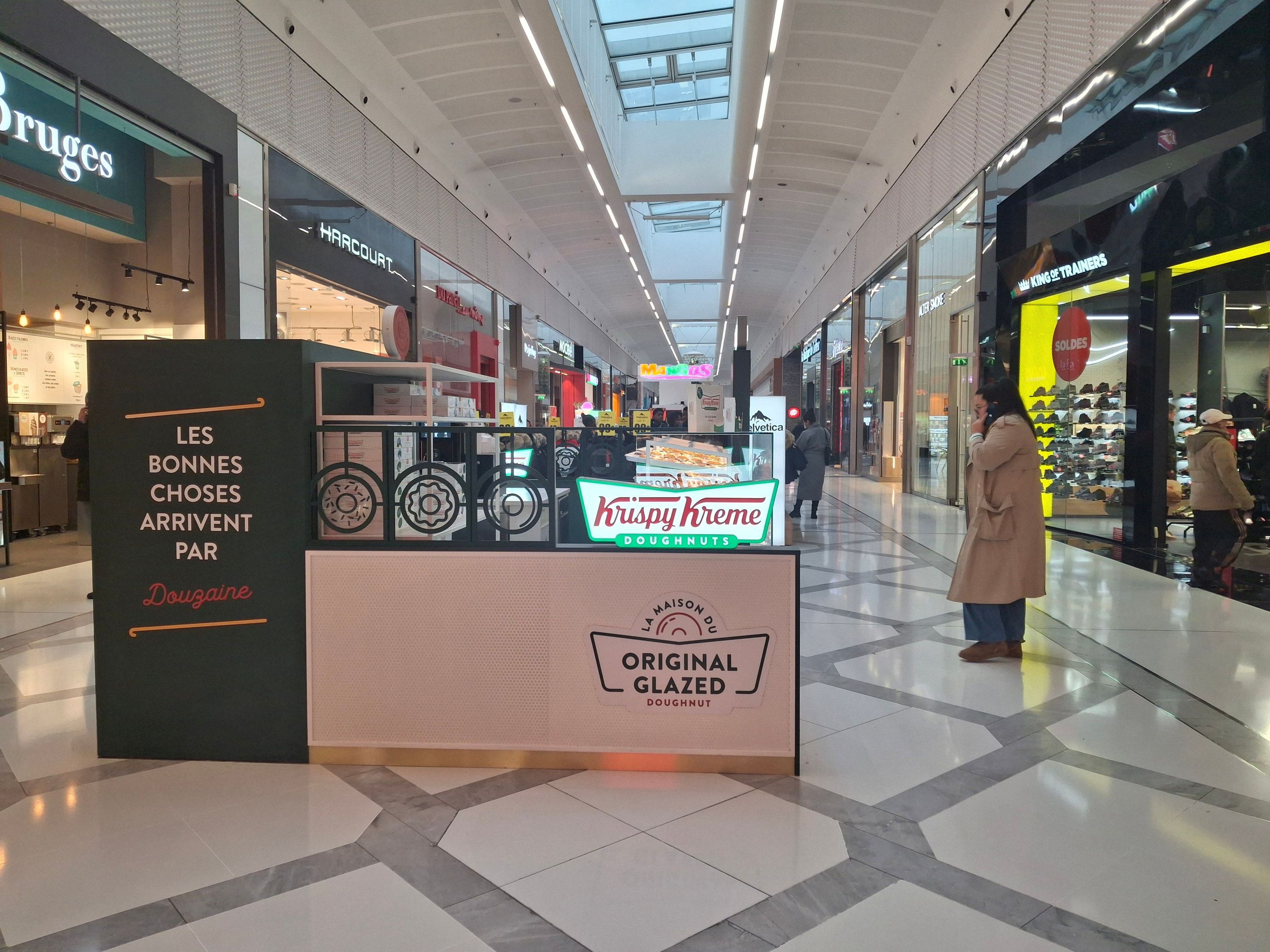 Krispy Kreme booth offers doughnuts and café for breakfast, open Sunday, in a shopping mall.