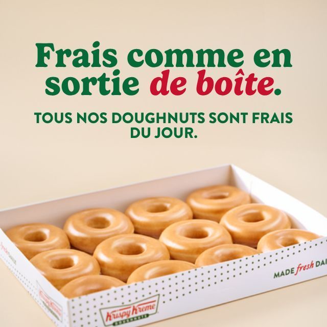 Boîte de doughnuts Krispy Kreme frais du jour, présentée dans un emballage blanc avec logo rouge et vert.